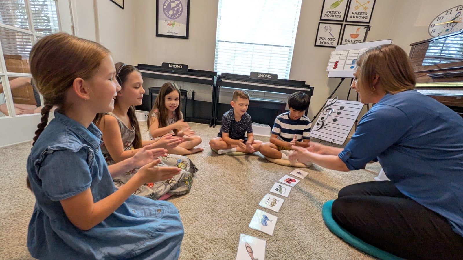 Ms. Shannon and her students clapping bug rhythms together
